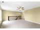 Spacious loft area with plush carpet, ceiling fan and staircase at 932 Silverheels Dr, Westfield, IN 46074