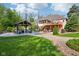 Spacious backyard with a well-manicured lawn, mature trees, an upper deck, a gazebo and a patio at 965 W Main St, Greenwood, IN 46142