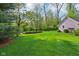 Picture of the large green backyard with a rock garden and a partial view of the white brick home at 965 W Main St, Greenwood, IN 46142