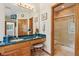 Bathroom vanity with wooden cabinets, granite counters and a separate shower room at 965 W Main St, Greenwood, IN 46142