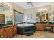 A stunning bathroom boasts a jacuzzi tub, and vanities, and natural light at 965 W Main St, Greenwood, IN 46142