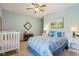 Bright bedroom with blue walls, ceiling fan, and neutral carpet at 965 W Main St, Greenwood, IN 46142
