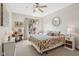 Relaxing bedroom featuring a ceiling fan, an accent wall mirror, and natural light at 965 W Main St, Greenwood, IN 46142