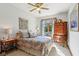 Bright bedroom featuring a ceiling fan, natural light, and attractive wood furniture at 965 W Main St, Greenwood, IN 46142