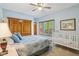 Light and airy bedroom with ceiling fan and a coordinating bedspread at 965 W Main St, Greenwood, IN 46142