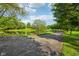Scenic view of property featuring mature trees and a tranquil pond at 965 W Main St, Greenwood, IN 46142