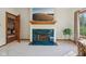A living room fireplace features a green marble hearth, wood mantel, and a flatscreen TV at 965 W Main St, Greenwood, IN 46142