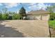 A spacious three-car garage is pictured with a basketball hoop and large driveway to accommodate parking needs at 965 W Main St, Greenwood, IN 46142