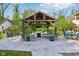 Covered gazebo with seating surrounding a fire pit and a view of the pool at 965 W Main St, Greenwood, IN 46142