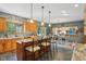 Spacious kitchen with wood cabinets, granite countertops, and island with seating open to the dining area at 965 W Main St, Greenwood, IN 46142