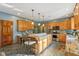 Spacious kitchen featuring a large island with granite countertops, wood cabinets, and modern appliances at 965 W Main St, Greenwood, IN 46142
