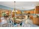 Bright kitchen and dining area featuring wood cabinets, a central island, and casual dining at 965 W Main St, Greenwood, IN 46142
