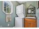 Functional laundry room with stacked washer and dryer, plus a sink and window at 965 W Main St, Greenwood, IN 46142