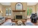 Cozy living room area with a fireplace, windows, and wood flooring at 965 W Main St, Greenwood, IN 46142