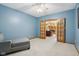 Blue room with neutral carpet, a chaise lounge, and french doors at 965 W Main St, Greenwood, IN 46142