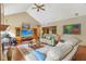 Bright living room featuring a vaulted ceiling, wood floors, and comfortable furnishings at 965 W Main St, Greenwood, IN 46142