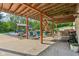 Covered patio with an outdoor kitchen, seating and backyard views with swing and stairs to the upper deck at 965 W Main St, Greenwood, IN 46142