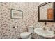 A charming powder room features wallpaper and vintage-style fixtures and sink at 965 W Main St, Greenwood, IN 46142