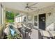 Cozy screened porch with a brick wall, comfortable seating, and tranquil outdoor views at 965 W Main St, Greenwood, IN 46142