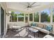 Relaxing sunroom featuring oversized windows offering a view of the beautiful backyard at 965 W Main St, Greenwood, IN 46142