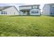 Spacious lawn with view of covered back porch for outdoor relaxation at 9822 Tampico Chase, Fishers, IN 46040