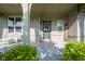 Inviting front porch featuring brick facade, black door with wreath, and cozy wicker seating at 9822 Tampico Chase, Fishers, IN 46040