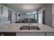 Open concept kitchen featuring granite counters, stainless steel sink, and sight lines to the dining room at 9822 Tampico Chase, Fishers, IN 46040