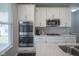Kitchen featuring built-in oven and microwave, tile backsplash, and light wood cabinets at 9822 Tampico Chase, Fishers, IN 46040