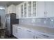 Modern kitchen featuring white cabinets, stainless steel appliances, and gray subway tile backsplash at 9822 Tampico Chase, Fishers, IN 46040
