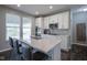 Bright kitchen with stainless steel appliances, island with seating, and ample natural light at 9822 Tampico Chase, Fishers, IN 46040