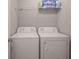 Laundry room featuring a white washer and dryer with storage shelves above at 9822 Tampico Chase, Fishers, IN 46040