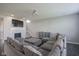 Spacious living area with a fireplace, staircase, large sectional, and gray wood flooring at 9822 Tampico Chase, Fishers, IN 46040