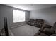 Upstairs living room featuring a plush reclining couch and a large window for natural light at 9822 Tampico Chase, Fishers, IN 46040