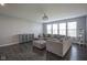 Cozy living room featuring a large sectional sofa, ottoman, and ample natural light from windows at 9822 Tampico Chase, Fishers, IN 46040