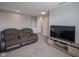 Upstairs living room featuring a plush reclining couch and a wall-mounted television at 9822 Tampico Chase, Fishers, IN 46040