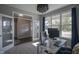 Stylish office with a modern desk, a decorative chandelier, and view to front yard at 9822 Tampico Chase, Fishers, IN 46040
