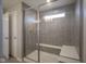Modern walk-in shower with a built-in bench and tiled walls at 9822 Tampico Chase, Fishers, IN 46040