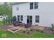 Charming backyard patio with outdoor seating and a brick fire pit, perfect for entertaining at 10316 Hatherley Way, Fishers, IN 46037