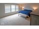 Spacious bedroom featuring soft carpet, natural light, and a cozy blue quilted bed at 10316 Hatherley Way, Fishers, IN 46037