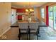 Open dining room with wood floors, backyard access, and adjacent kitchen at 10316 Hatherley Way, Fishers, IN 46037