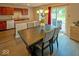 Open dining room showcasing backyard access and a view of the kitchen and bar seating at 10316 Hatherley Way, Fishers, IN 46037