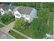 Aerial view of a two-story home with a well-kept lawn, complemented by mature trees and neighborhood views at 10316 Hatherley Way, Fishers, IN 46037