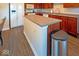 Kitchen island with countertop, stainless steel trash can, and white appliances at 10316 Hatherley Way, Fishers, IN 46037