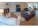 Inviting living room with a cozy fireplace, plush seating, and wood-look floors at 10316 Hatherley Way, Fishers, IN 46037