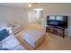 Cozy living room with neutral walls, carpet, couch, TV, and ottoman at 10316 Hatherley Way, Fishers, IN 46037