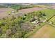 Serene aerial shot of a rural property showcasing a home, verdant trees, and open fields at 10473 N County Road 950 E, Brownsburg, IN 46112