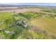 A sprawling aerial view shows a residence surrounded by fields, trees and natural beauty at 10473 N County Road 950 E, Brownsburg, IN 46112
