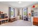 Bright bedroom with ample shelving, a wooden desk, and two large windows at 10473 N County Road 950 E, Brownsburg, IN 46112