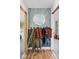 Stylish entryway featuring patterned wallpaper, a round mirror, and coat rack at 10473 N County Road 950 E, Brownsburg, IN 46112