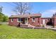 Charming single-story brick house featuring a manicured lawn, complemented by a detached garage at 10473 N County Road 950 E, Brownsburg, IN 46112
